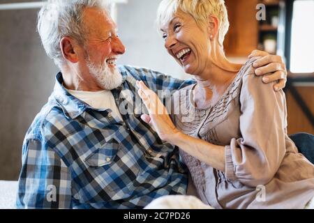 Happy senior couple in love hugging and bonding with true emotions at home Stock Photo