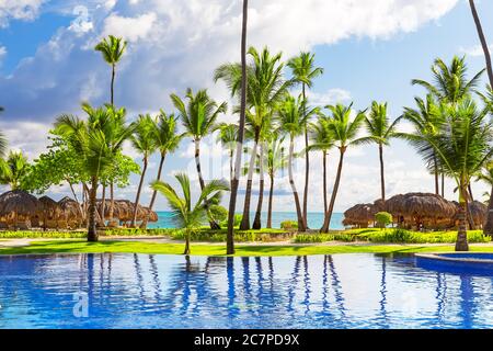 Tropical beach resort with umbrellas and lounge chairs in Punta Cana, Dominican Republic Stock Photo