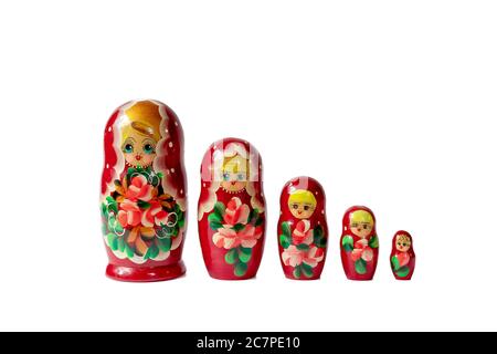 Russian folk crafts wooden nesting dolls in a row lined up in a row on a white background Stock Photo