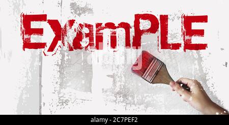 Example written with red paintbrush on a wall. Conceptual image Stock Photo