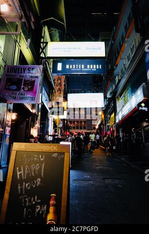 Lan Kwai Fong (LKF) at night. Popular area in Central for drinking, clubbing and dining. Colorful neon lights of bar street. Stock Photo