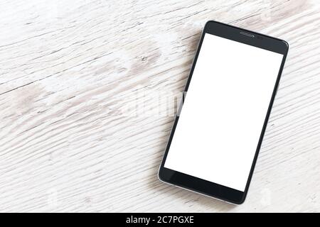 Black smart phone with isolated screen on wooden table Stock Photo