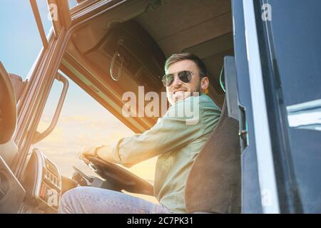 Lorry or truck driver sitting in the cabin of his vehicle Stock Photo ...