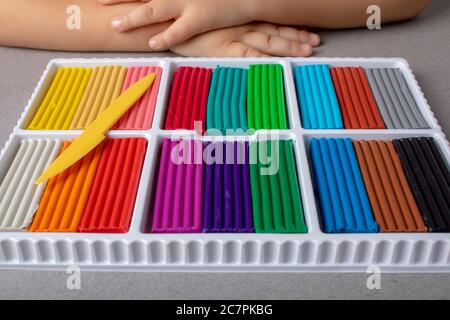 Colorful plasticine sticks in a cardboard box. educational games concept Stock Photo