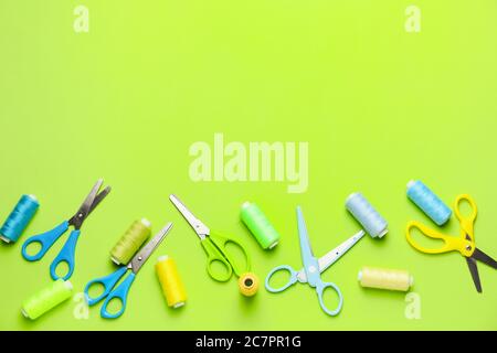 Scissors with sewing threads on color background Stock Photo