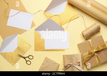 Composition with blank cards, gifts and envelopes on color background Stock Photo