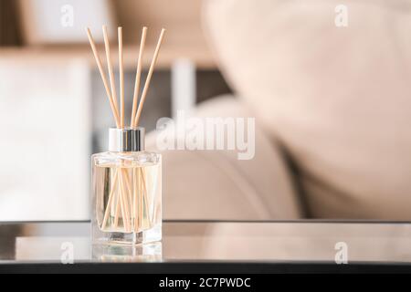 Reed diffuser on table in room Stock Photo