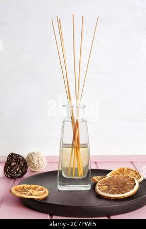 Citrus reed diffuser on table in room Stock Photo