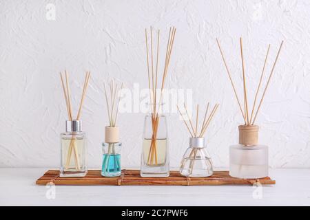 Different reed diffusers on table in room Stock Photo