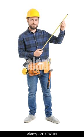 Male worker with tape measure on white background Stock Photo