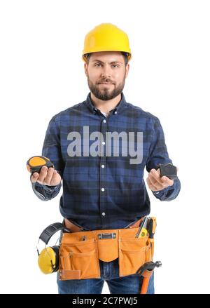 Male worker with measuring tapes on white background Stock Photo