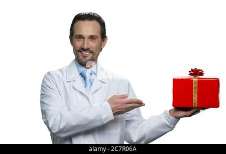 Successful doctor is pointing at the gift. Stock Photo