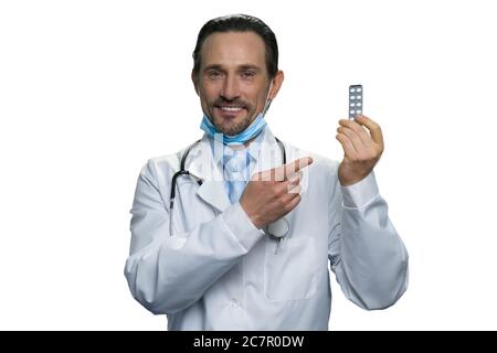 Smiling doctor holding the blister pack of tablets. Stock Photo