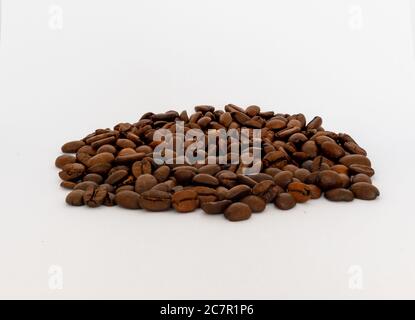 Bunch of roasted coffe beans against a white background Stock Photo