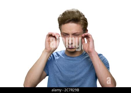 Teenage boy with headache isolated on white background. Stock Photo
