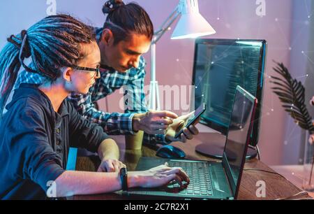 Programmers are developing software by working with software code together. Team work. Modern job of web ux Designer Stock Photo