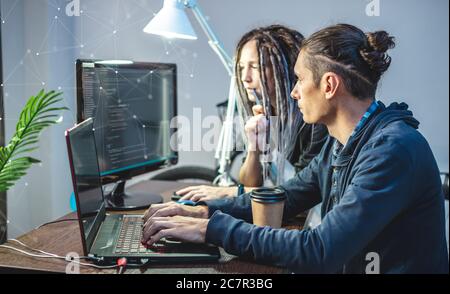 Programmers are developing software by working with software code together. Team work. Modern job of web ux Designer Stock Photo