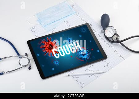 Tablet pc and doctor tools on white surface with COUGH inscription, pandemic concept Stock Photo