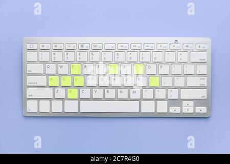 PC keyboard with several yellow keys on color background. Dyslexia concept Stock Photo