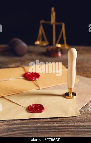 Envelopes with notary public wax seals on table Stock Photo
