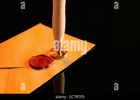 Envelope with wax seal stamp of notary public on dark background Stock Photo