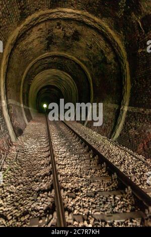 Light at the end of train tunnel Stock Photo