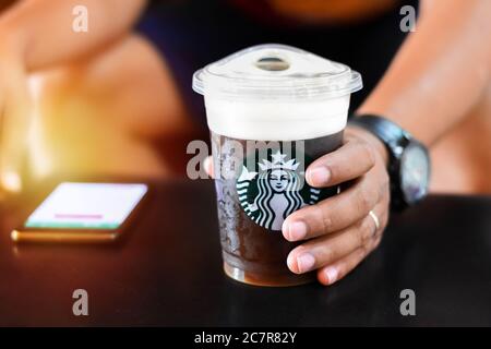 Chon Buri, Thailand - October 14, 2018: Starbucks coffee brand logo on cold brew beverage cup. Starbucks is the world's largest coffee house Stock Photo