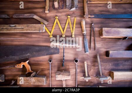 Overhead view of construction tools organized on a wooden floor Stock Photo