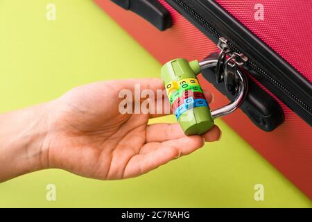 Woman with lock on suitcase, closeup Stock Photo