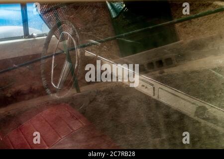 Volvo 122S Sedan car interior steering wheel and dashboard seen through side window with dust parked in Playa San Juan, Tenerife, Canary Islands, Spai Stock Photo