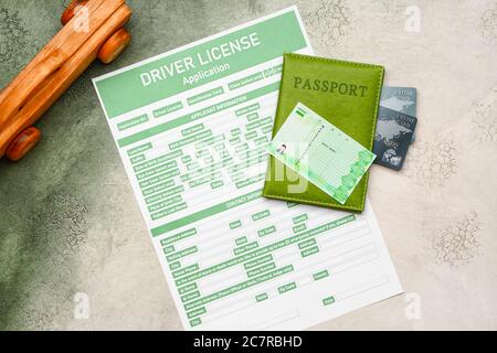 Driving license with application form, passport and credit cards on color background Stock Photo