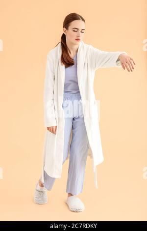 Female sleepwalker on color background Stock Photo