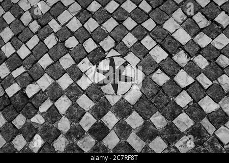 Typical portuguese cobblestone hand-made mosaic pavement, in Lisbon, Portugal. Stock Photo