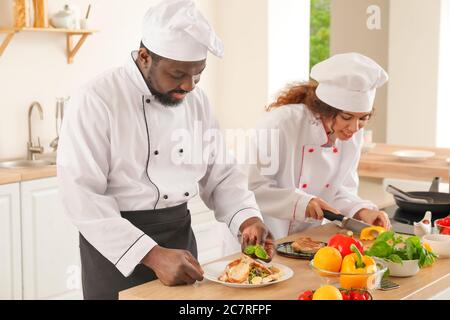 African-American chefs cooking in kitchen Stock Photo