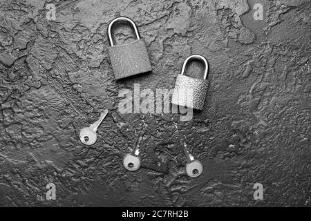 Keys with locks on dark background Stock Photo