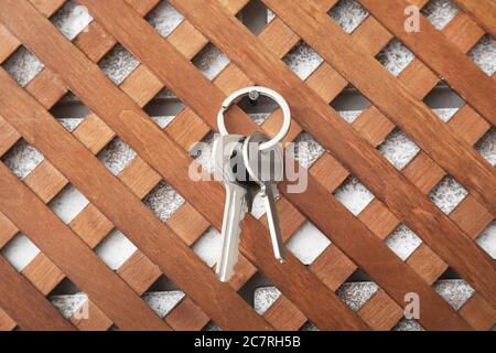 Keys from house hanging on wall in room Stock Photo