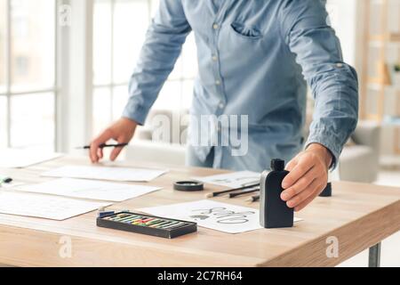 Senior male calligraphist working in office Stock Photo