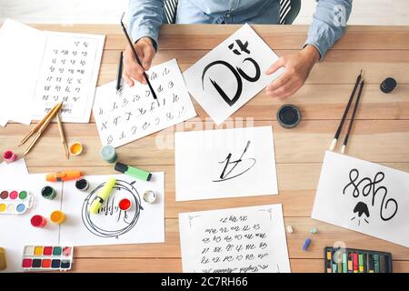 Senior male calligraphist working in office Stock Photo