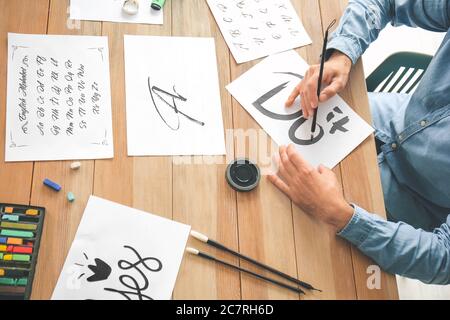 Senior male calligraphist working in office Stock Photo
