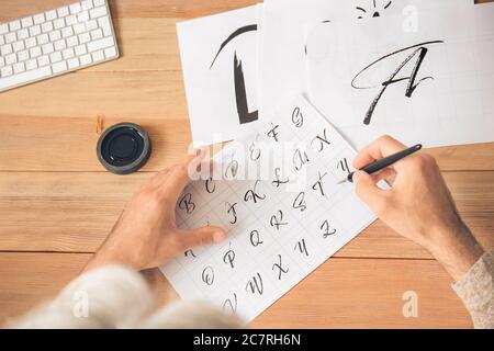 Senior male calligraphist working in office Stock Photo