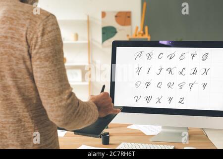 Senior male calligraphist working in office Stock Photo