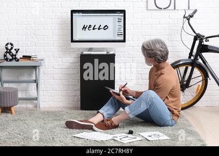 Senior male calligraphist working in office Stock Photo