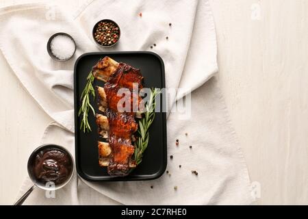 Tasty beef short ribs with sauce on table Stock Photo