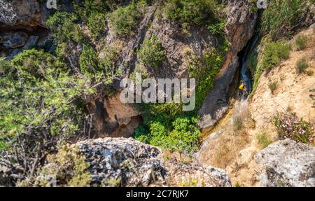 Top view of two unrecognizable persons canyoning with ropes Stock Photo