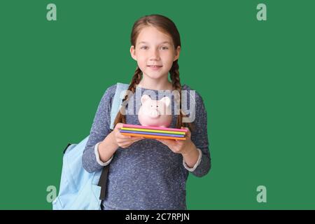 Girl with savings for education on color background Stock Photo