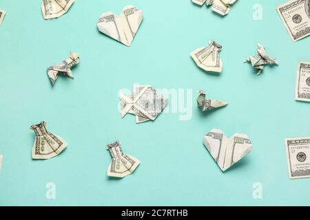 Origami figures made of dollar banknotes on color background Stock Photo
