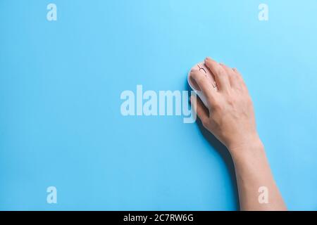 Female hand with modern computer mouse on color background Stock Photo