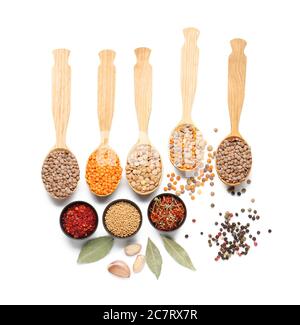 Spoons with lentils and spices on white background Stock Photo