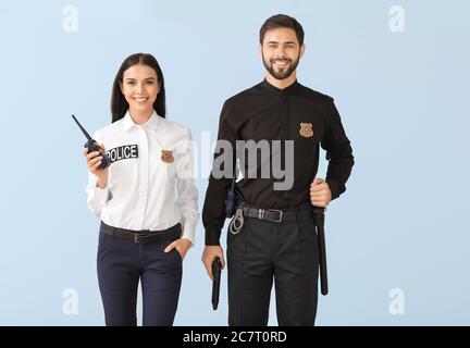 Two male police officers arrest young woman Stock Photo - Alamy