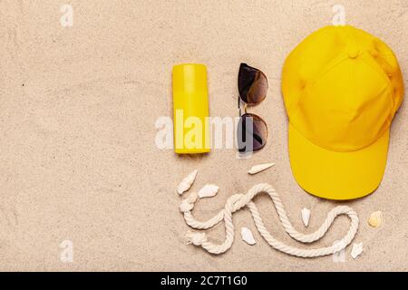 Stylish beach accessories on sand background Stock Photo